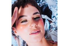 woman's face on shiny sliver background posing